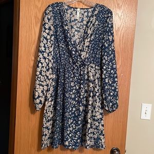 This vanilla baby dress has an elastic waist and long sleeves